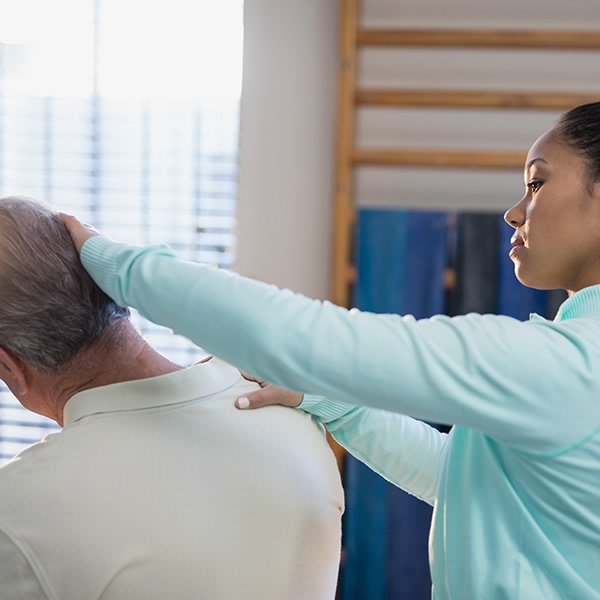 Chiropractor examining a patient's neck at Chiropractic Health of Charlotte
